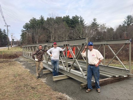 Volunteers assemble bridge for greenway trail