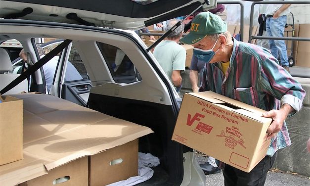 Volunteers help with food distribution