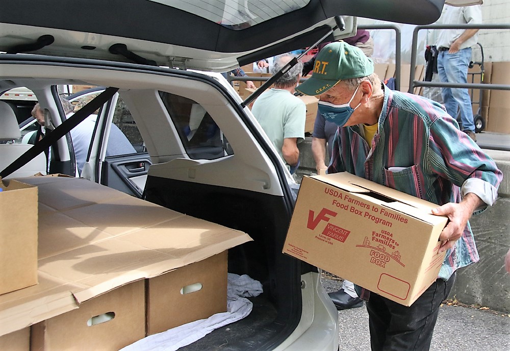 Volunteers help with food distribution