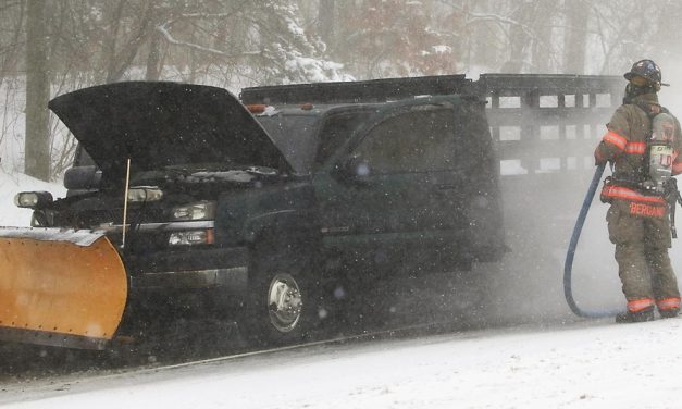 Firefighters battle truck fire and storm