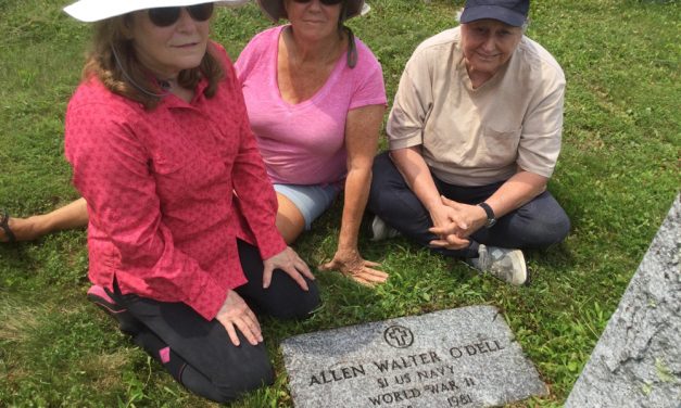 Volunteers clean Allen O’Dell’s gravestone