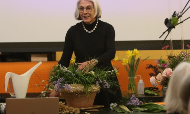 Flower arranger presents to garden club
