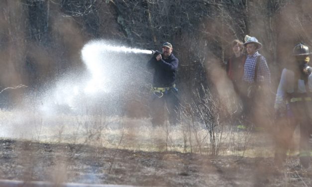 Wind-driven fire burns grass and brush