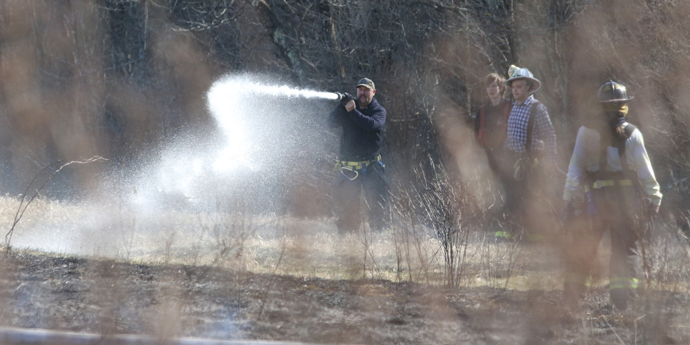 Wind-driven fire burns grass and brush