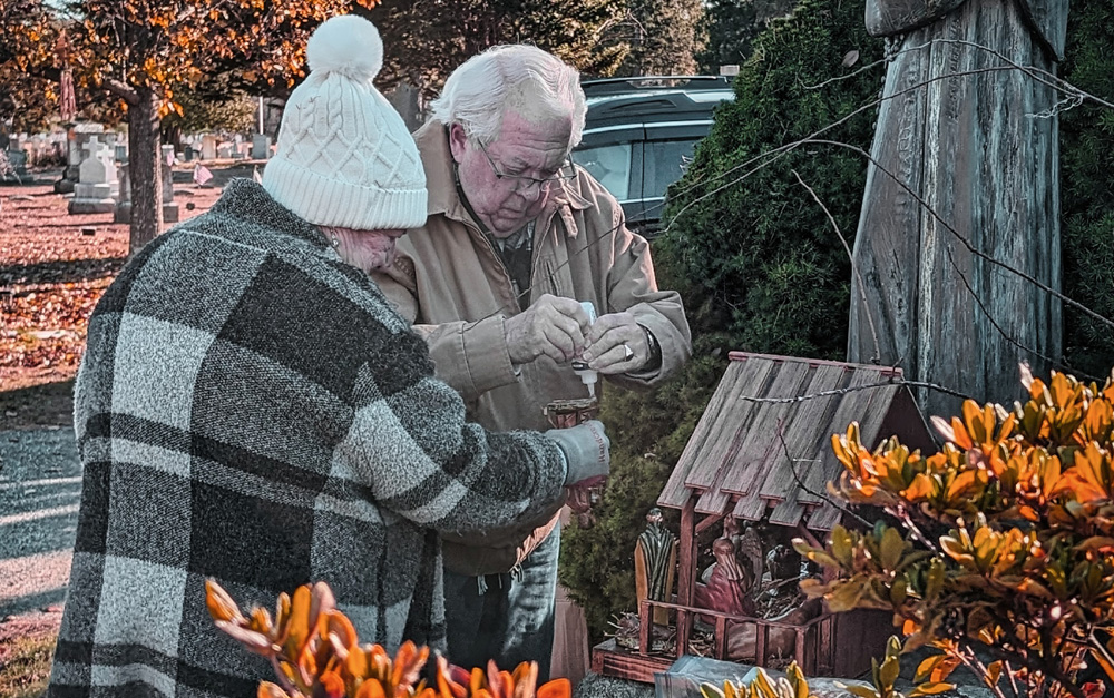 Volunteers place creche at cemetery