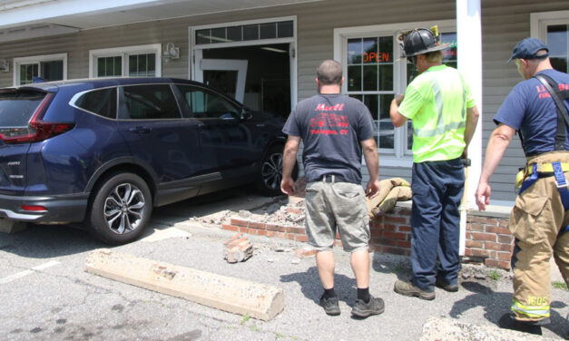 Vehicle strikes building at Village Green