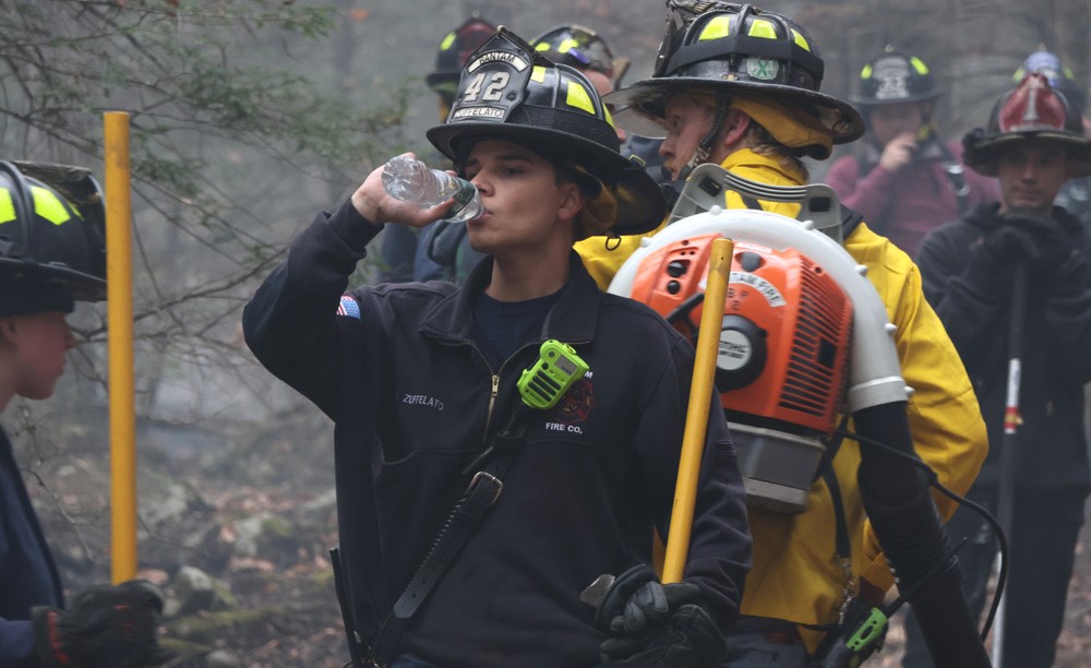 Local firefighters help smother brush fire