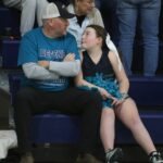 Dad and daughter take in the hoop games