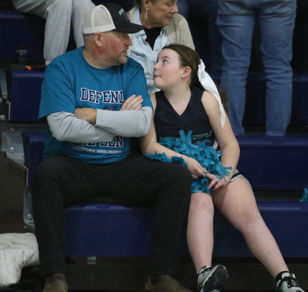 Dad and daughter take in the hoop games