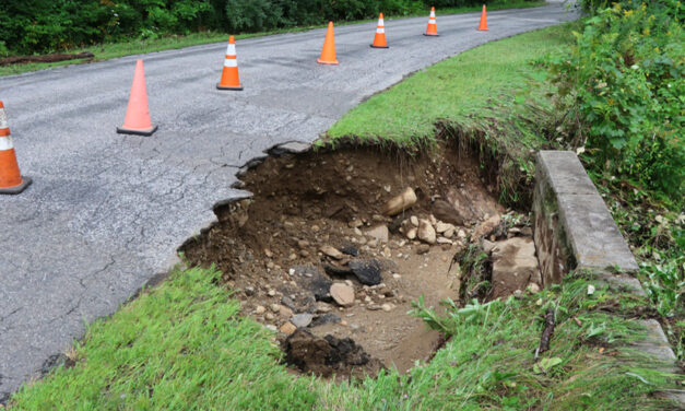 Wall of water damages road in Warren