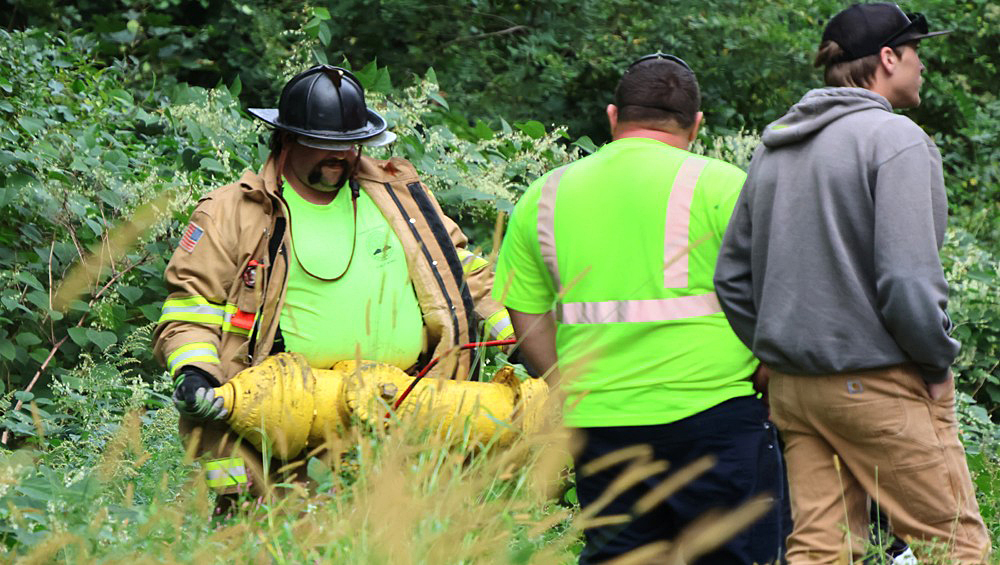Vehicle veers off road, strikes hydrant